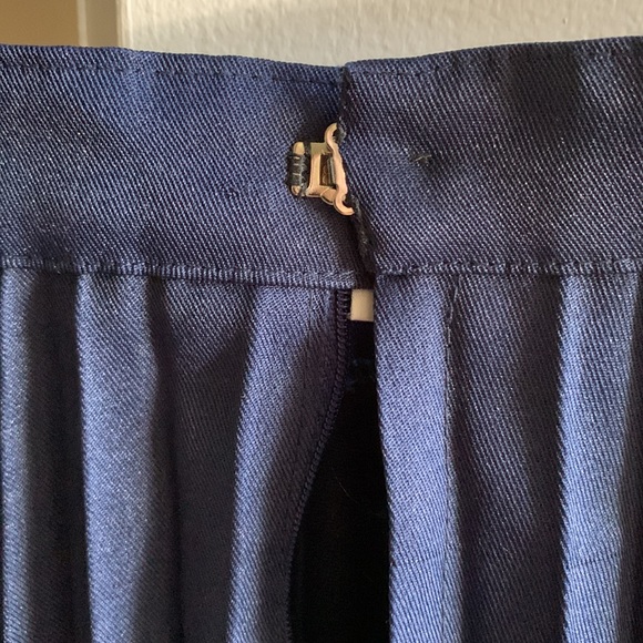 Pleated skirt is in navy blue color. - Picture 5 of 5